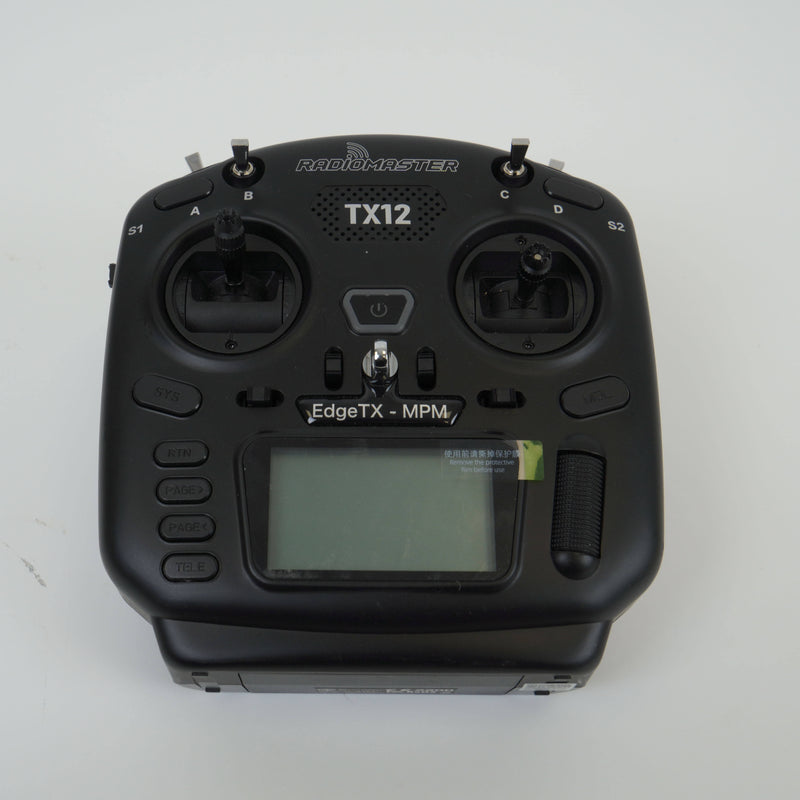 Black RC remote controller with dual joysticks and LCD screen, RADOMASTER TX12