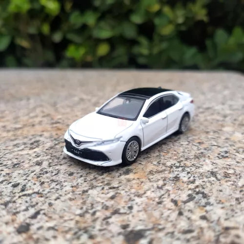 White diecast sedan model car, front 3/4 view with detailed grille