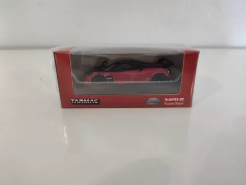 Red and black diecast model car in display box with clear window