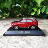 Red 1/43 diecast SUV model on dark display base with black text
