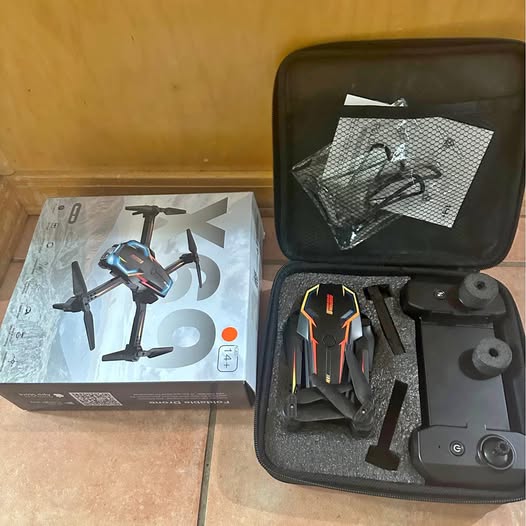 FPV drone kit in hard case with remote controller and folded drone propellers