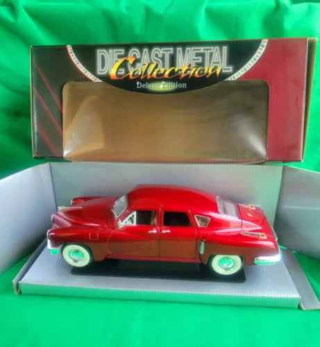 Red diecast model car in display box, chrome details and whitewall-style tires