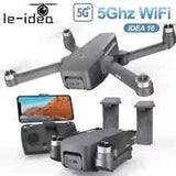 Grey quadcopter drone with onboard camera, remote controller, and two batteries