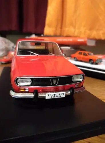 Red front-view diecast car model with chrome bumper, grille, and headlights