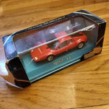 Red diecast sports car model in display box