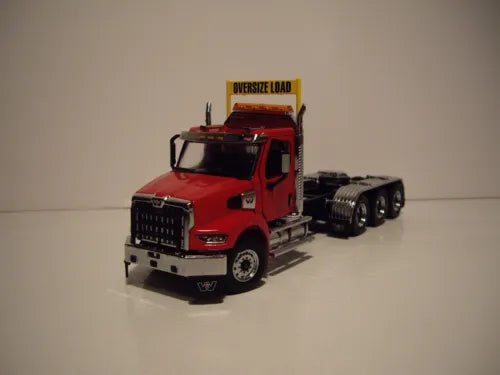 Red die-cast tri-axle truck model with chrome grille and cab with sleeper