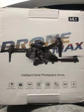 Foldable black quadcopter drone with mounted HD camera on retail box
