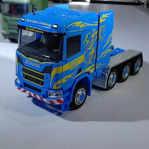 Blue SCANIA R650 diecast truck cab model with gray flat trailer bed, metal, 1:64