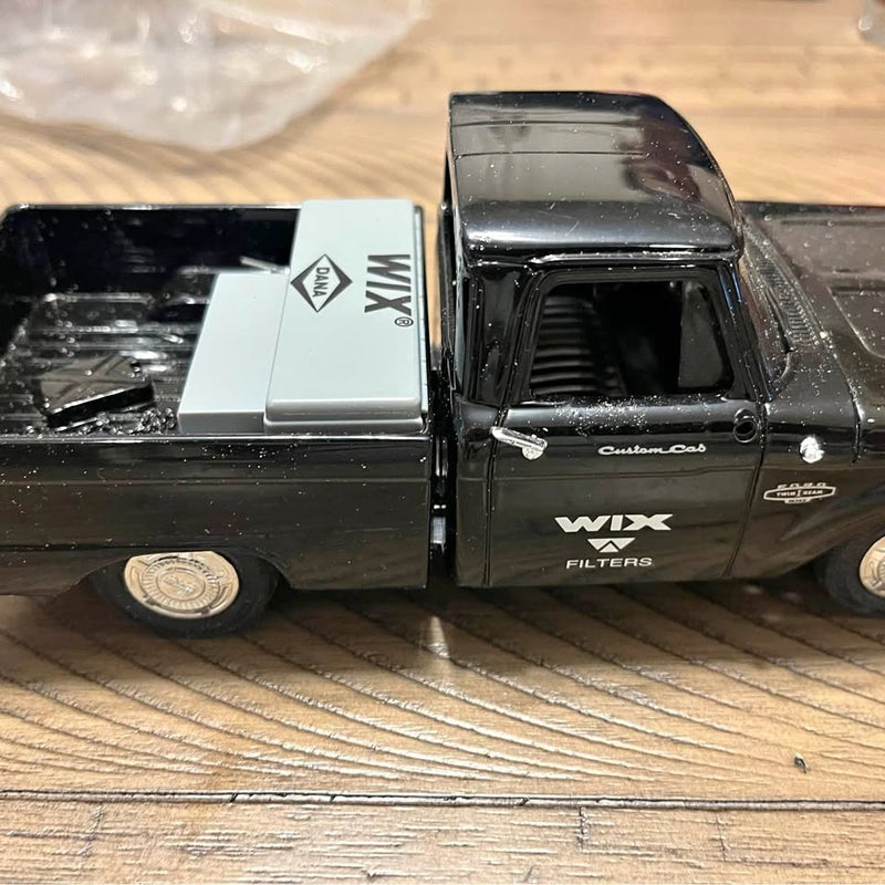 Diecast promotional pickup truck model in dark gray/black with logo on side panel