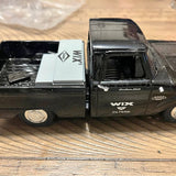 Diecast promotional pickup truck model in dark gray/black with logo on side panel