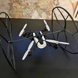 Quadcopter drone with four white propellers and black body