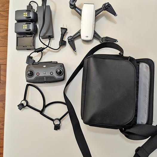 DJI drone accessory kit with folding quadcopter, controller, batteries, charger, carrying bag