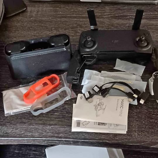 DJI Mavic Mini drone with propeller arms and remote controller accessories