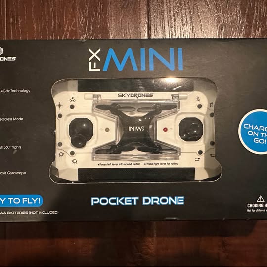 FX Mini pocket drone in retail blister pack, showing controller and prop housings
