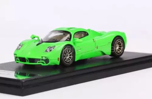 Green sports model diecast car with black wheels on display base