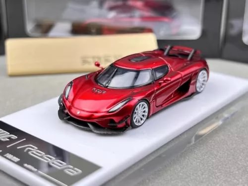 Red racing sports model diecast car with black wheels and front grille detail