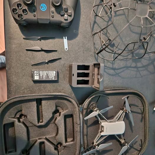 Carrying case with foam insert holding remote, drone battery, charger and propellers