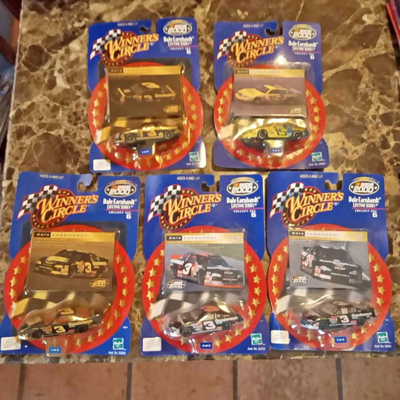 Diecast car toy in red-and-blue blister package, yellow car visible through window