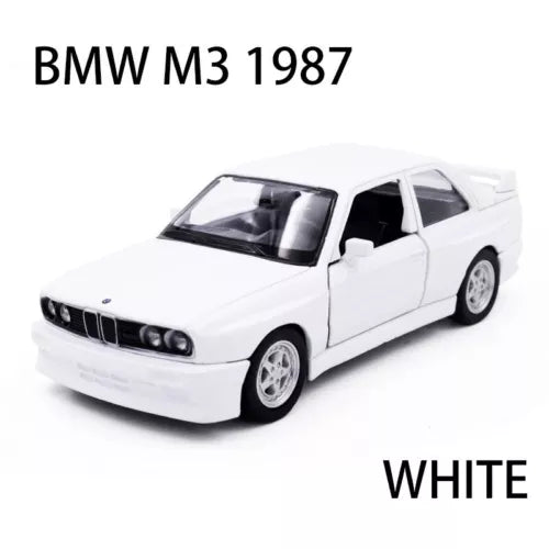 White 1987 BMW M3 sedan diecast metal car model, front three-quarter view