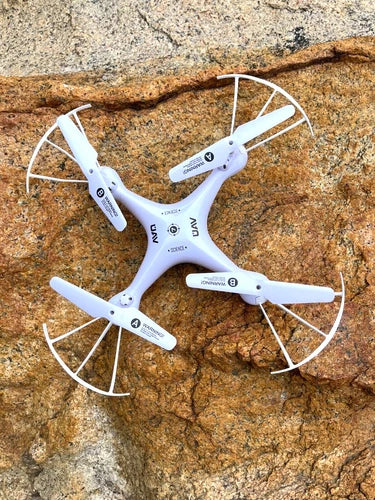 White quadcopter drone with four arms and circular prop guards