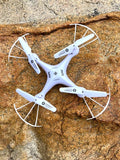 White quadcopter drone with four arms and circular prop guards