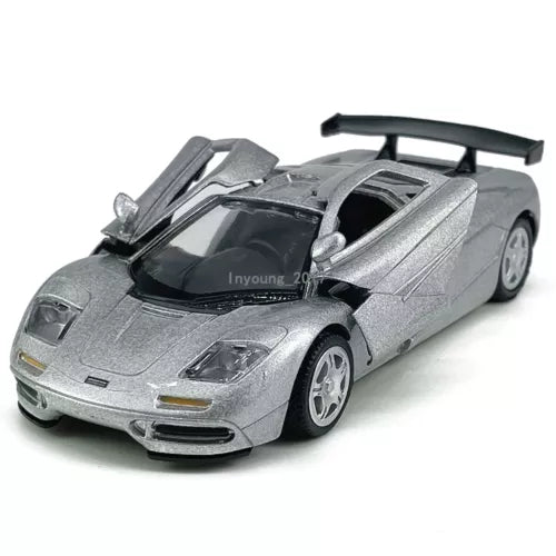 Silver diecast sports car model with black cockpit and rear spoiler