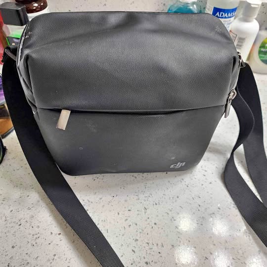 Dji drone shoulder bag with front flap and crossbody strap, dark gray
