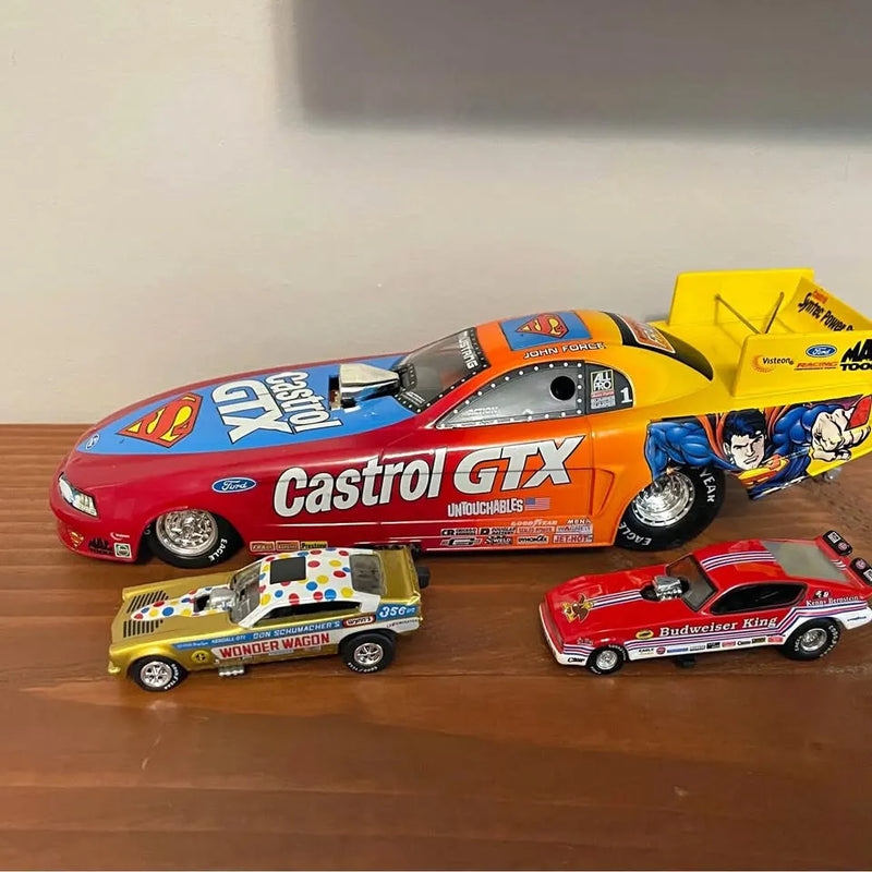 Diecast NHRA model car set with four racing cars: red Castrol GTX, yellow, white, red Budweiser.