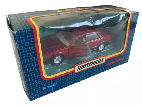 Diecast model car box with metallic red Jaguar XJ6