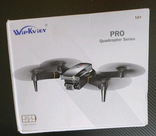 Foldable RC drone on retail box, black and gray quadcopter with camera