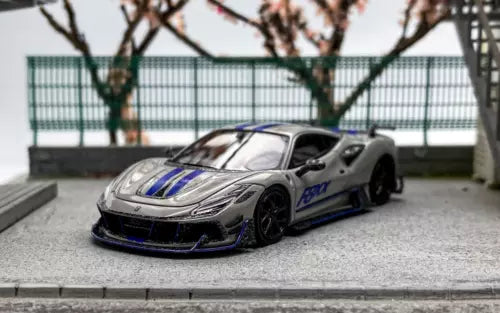 Gray racing sports diecast car model with blue racing stripe and front splitter