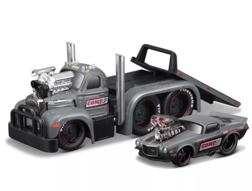 Diecast flatbed trailer model with gray truck bed and black ramps, towing two cars