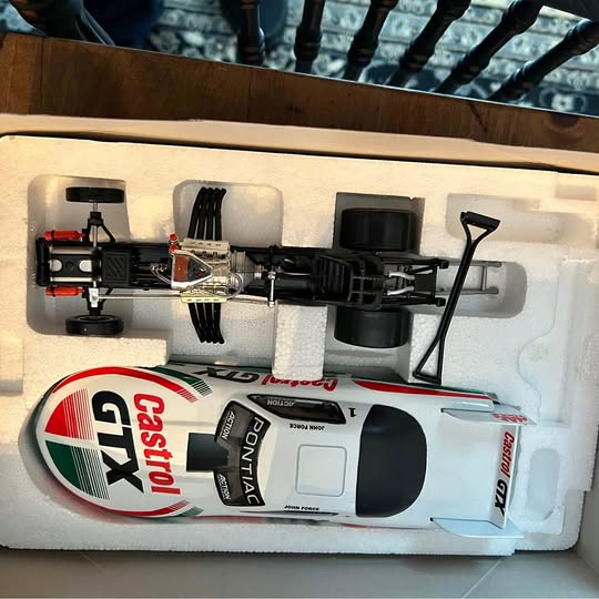 White vintage drag racing diecast car with red and green Castrol logo, black details
