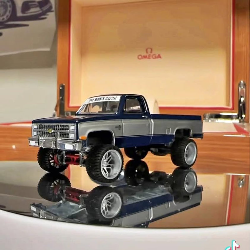 Two-tone blue and white diecast pickup truck model, front three-quarter view