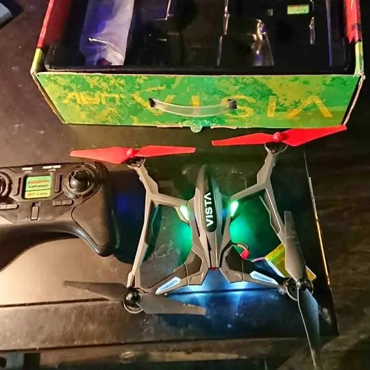 DROMIDA VISTA quadcopter drone with green and blue body, white arms, propellers