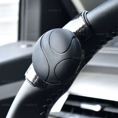 Diecast model car steering wheel in dark gray with embossed center detail