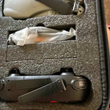 Gray folding drone with prop guards and top control module