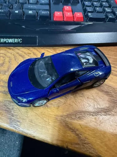 Blue diecast car model with open cockpit, side view