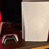 PlayStation 5 console with black wireless controller, white front panel