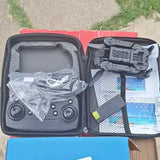 Mini drone kit with controller and carry case, shown with manuals and parts