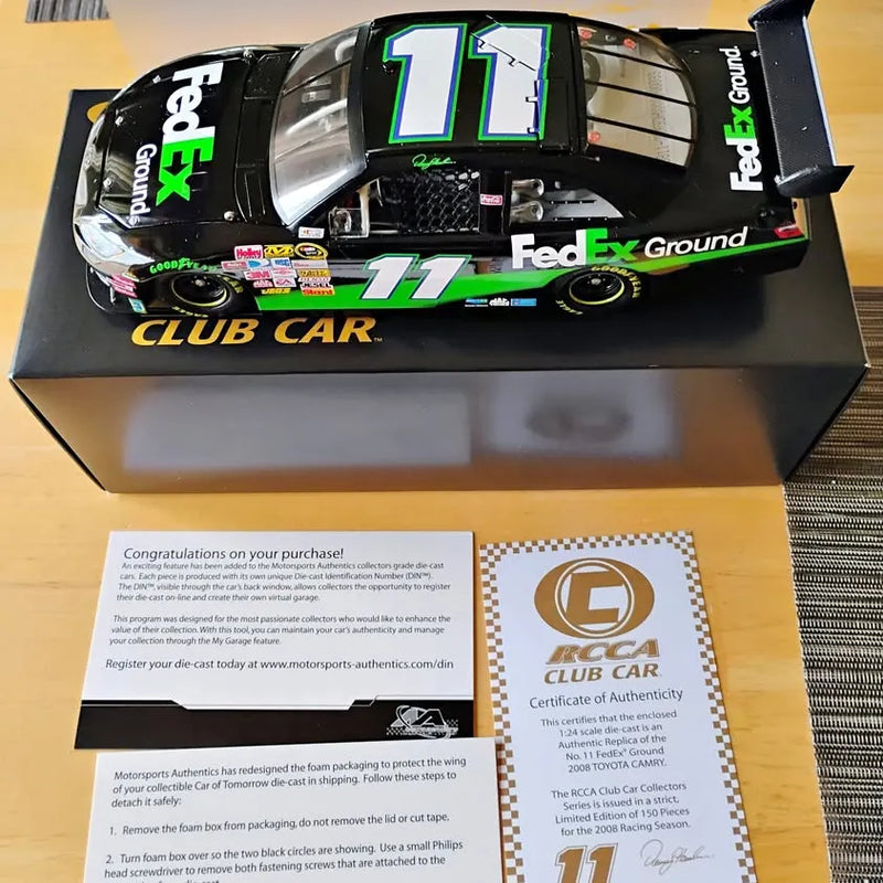 Black and green NASCAR diecast car model with #11 on hood and FedEx Ground logo