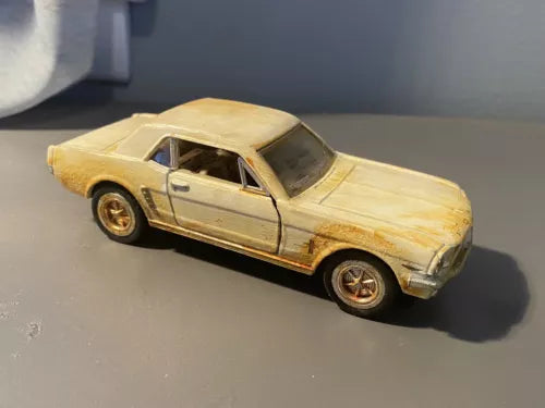 Rusted diecast toy car, 1964 1/2 Ford Mustang style, light yellow with gold wheels