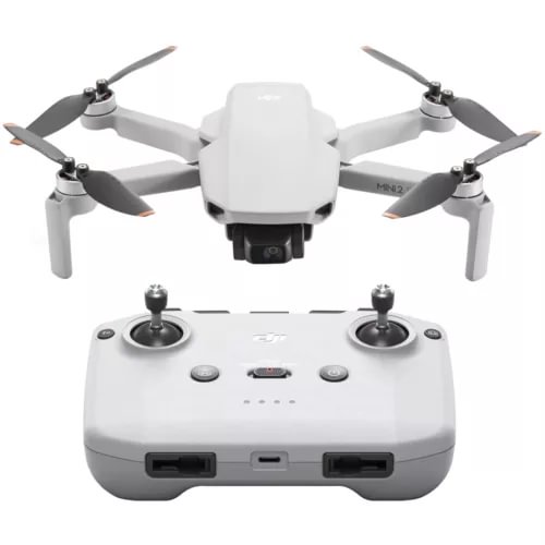 White foldable quadcopter drone with four propellers and front camera; controller shown.