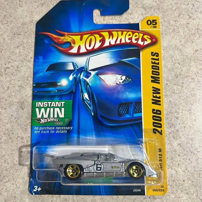 Blue 1:64 diecast race car in blister packaging with open-wheel design