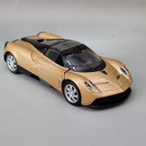 Pagani Huayra diecast model car, gold body with black hood and roof, silver wheels