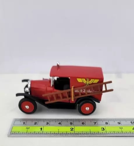 Red diecast fire engine truck with ladder, front-left side view
