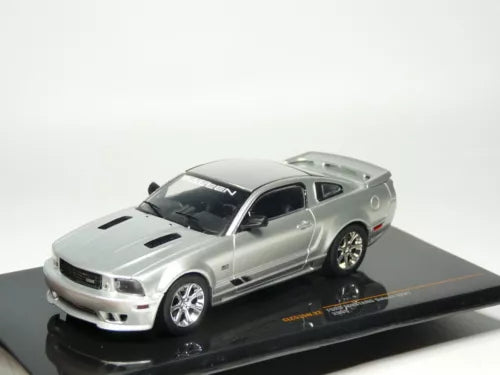 Silver 1:43 diecast model car of a Mustang, with black hood vents on display base