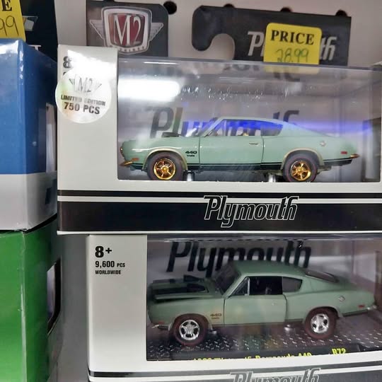 Teal die-cast model car in clear blister pack with Plymouth logo