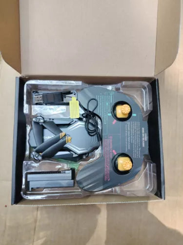 Mini FPV drone kit with drone, controller, cables, and instruction booklet in box