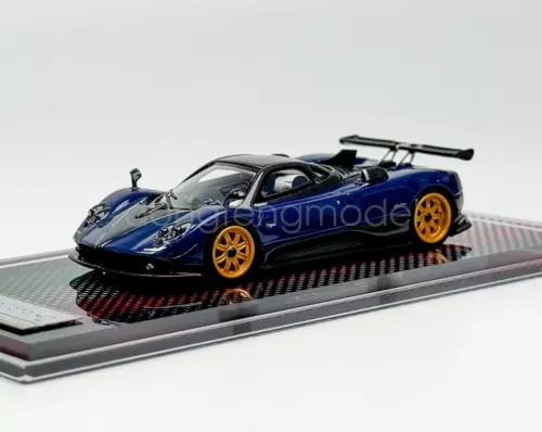 Blue racing sports diecast model car with black rear wing, 1:64 scale